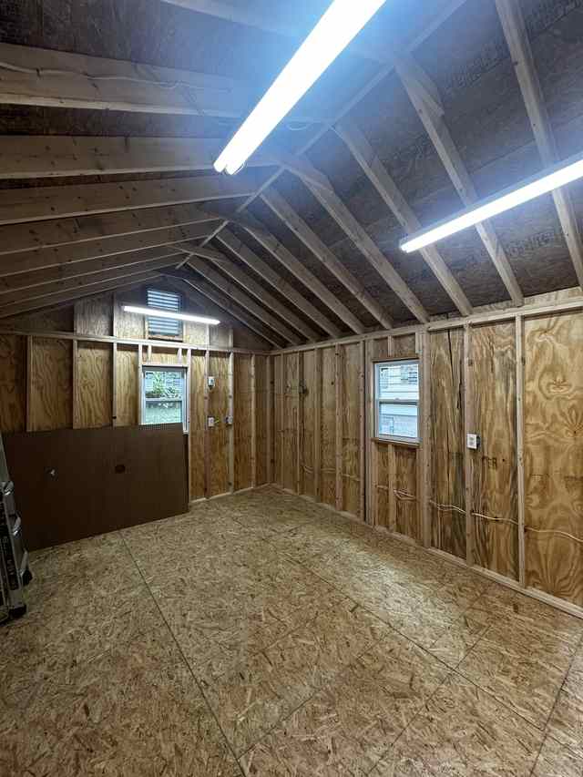 Rebuilt shed interior with new framing and roof deck
